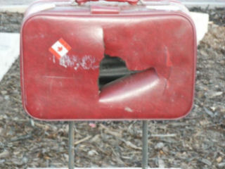 This suitcase was slashed by vandals.