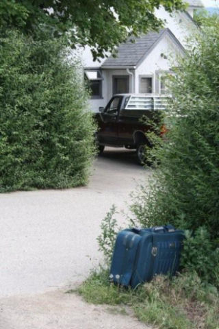 People put suitcases out by the side of the road to celebrate the arrival of Frank The Baggage Handler